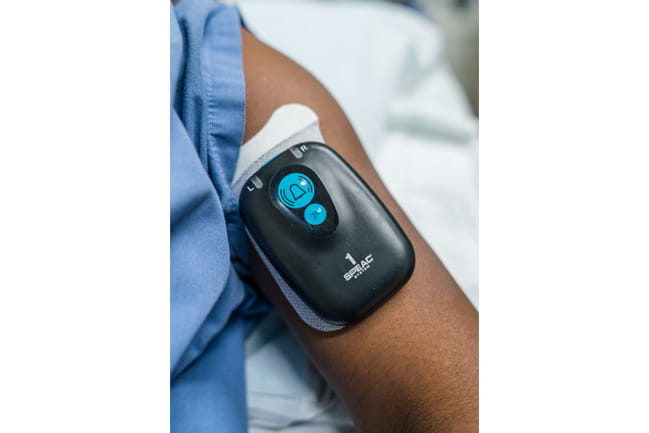 person wearing device that continuously records EMG activity in the bicep