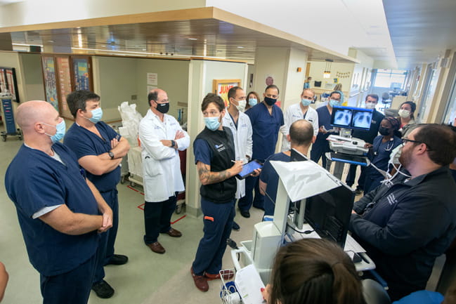 Doctors and other medical providers perform rounds in the cardiovascular intensive care unit in June. 