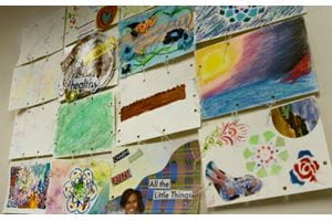 Artwork displayed along a wall. 